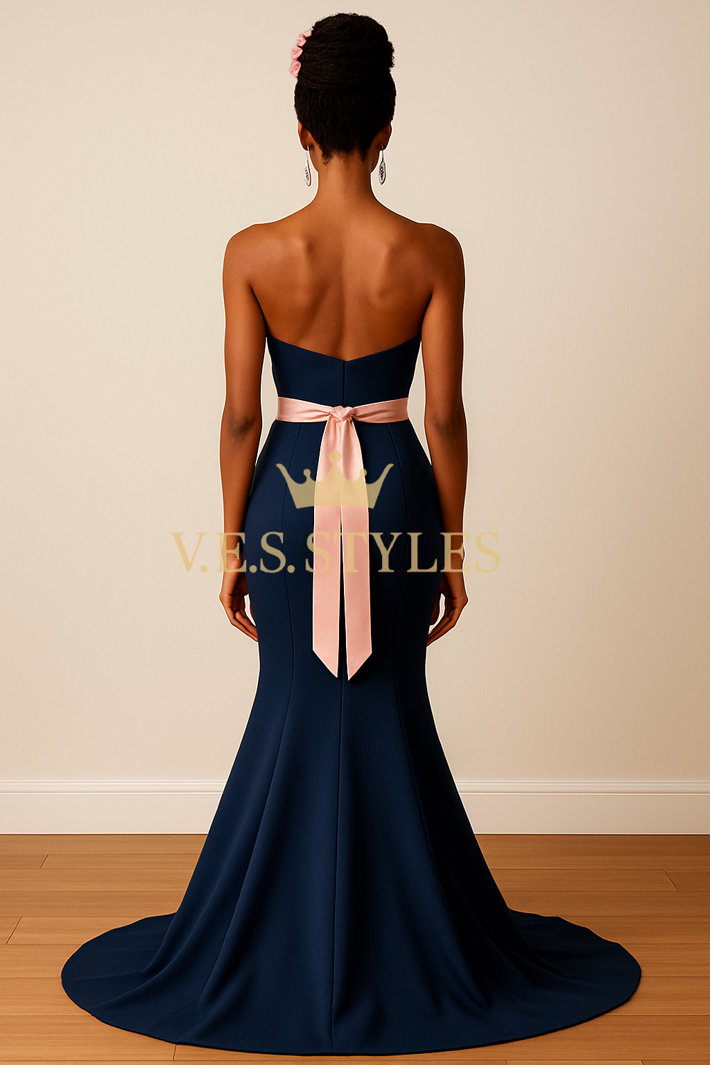 Navy blue strapless gown with a pink ribbon on a plain background– V.E.S. Styles
