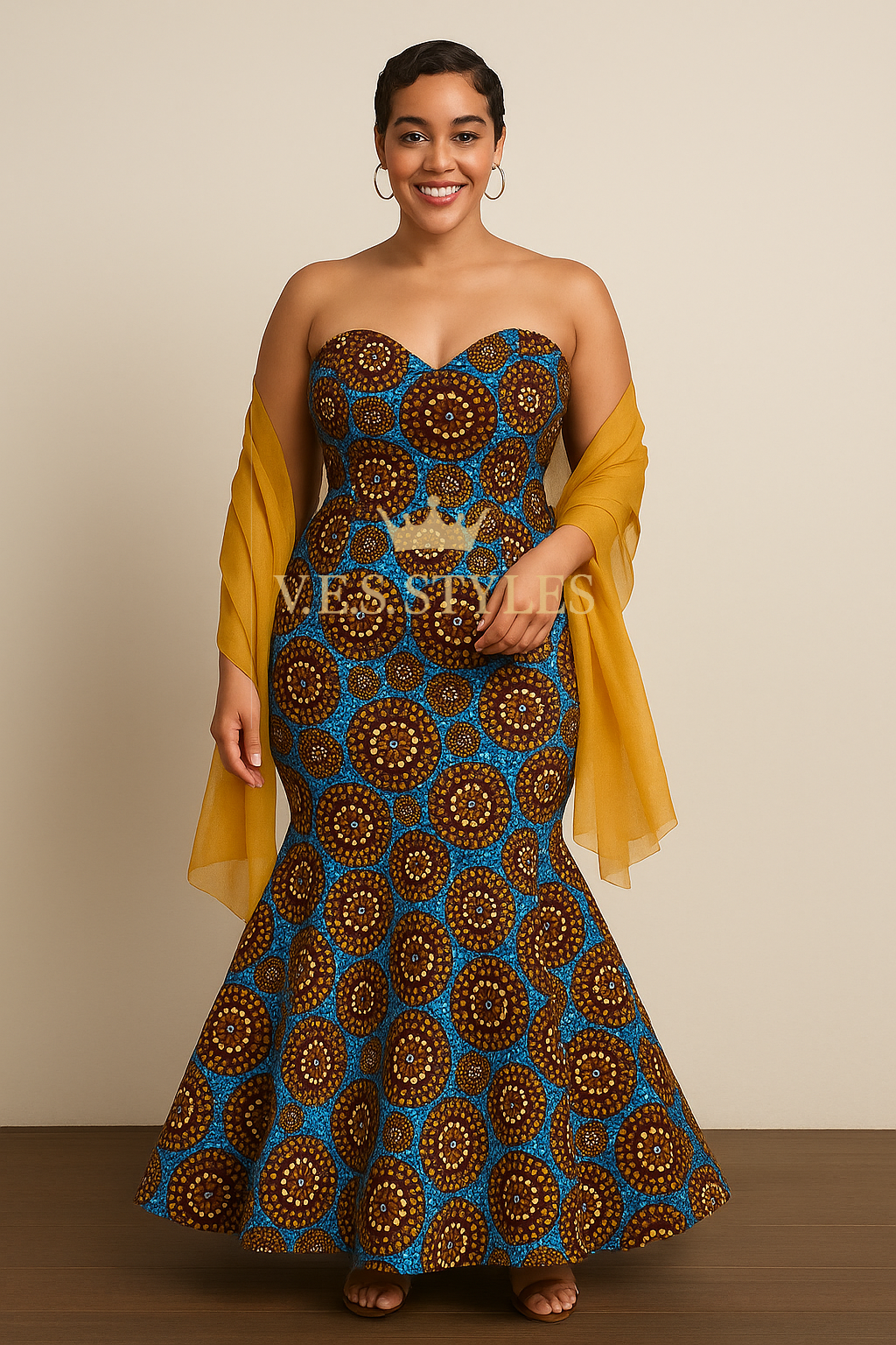 Woman wearing a strapless dress with a blue and brown pattern and yellow sleeves against a beige background.– V.E.S. Styles