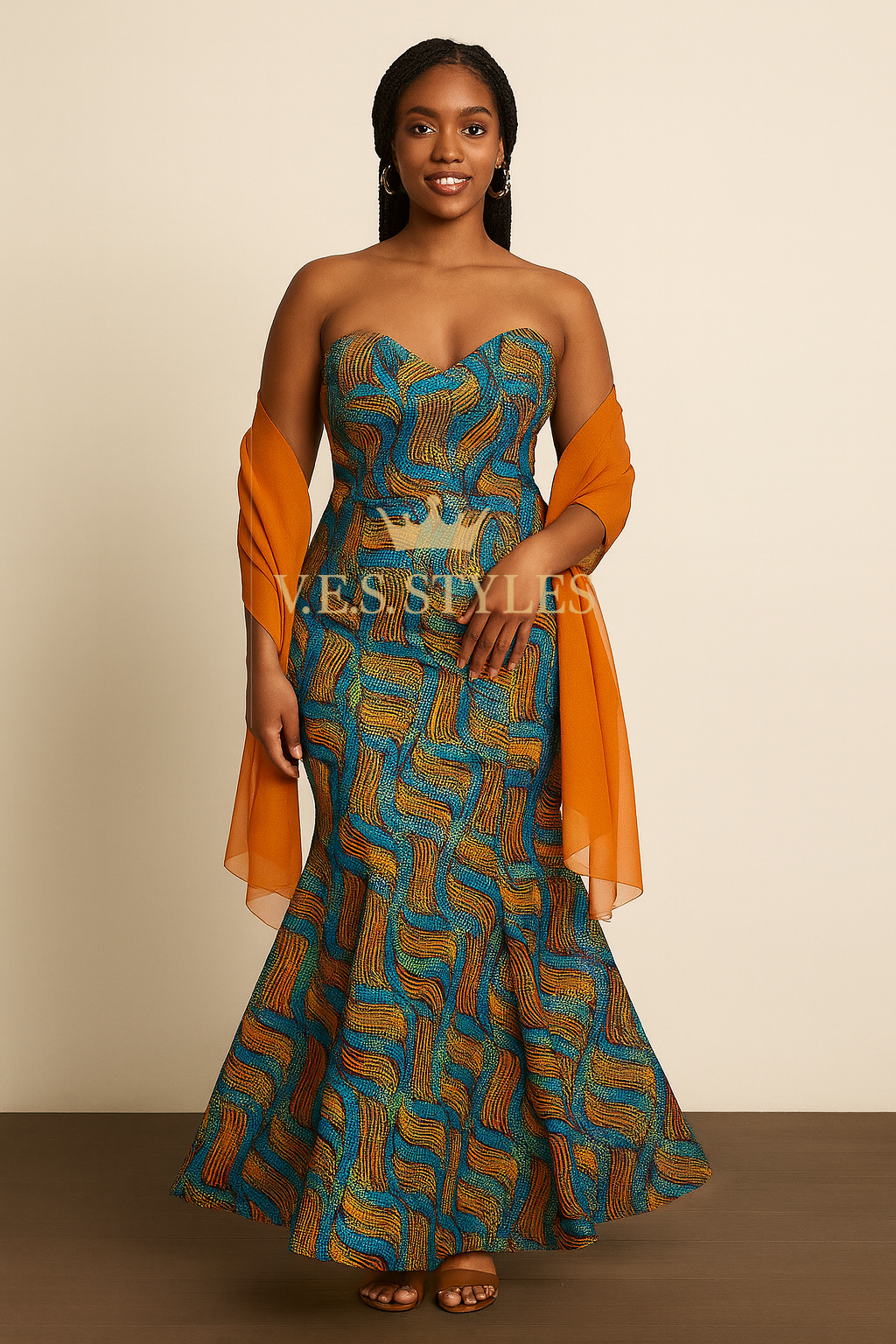 Woman wearing a strapless dress with orange and blue pattern against a beige background– V.E.S. Styles
