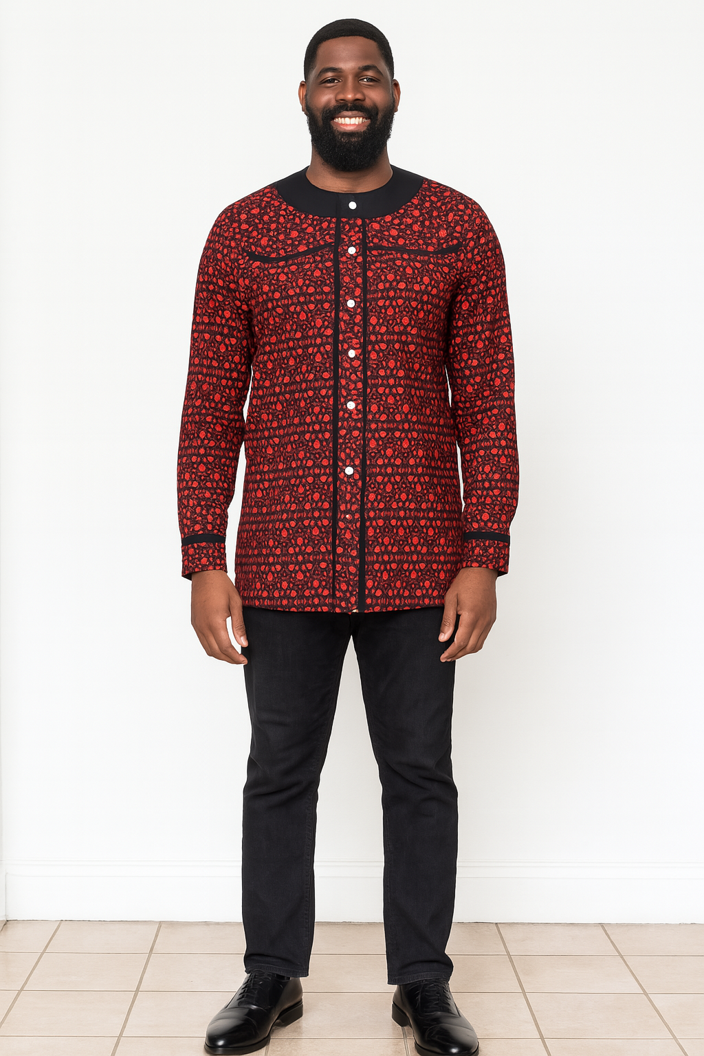 "Man is wearing a red, white and black patterned Ankara long-sleeved shirt with white buttons running all the way down the front — V.E.S. Styles Trinidad and Tobago."
